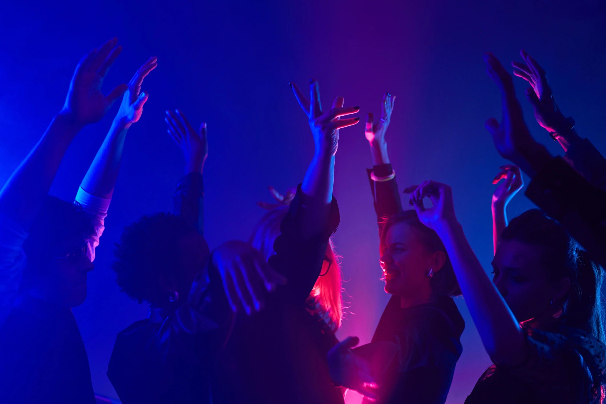 Crowd dancing under neon lights