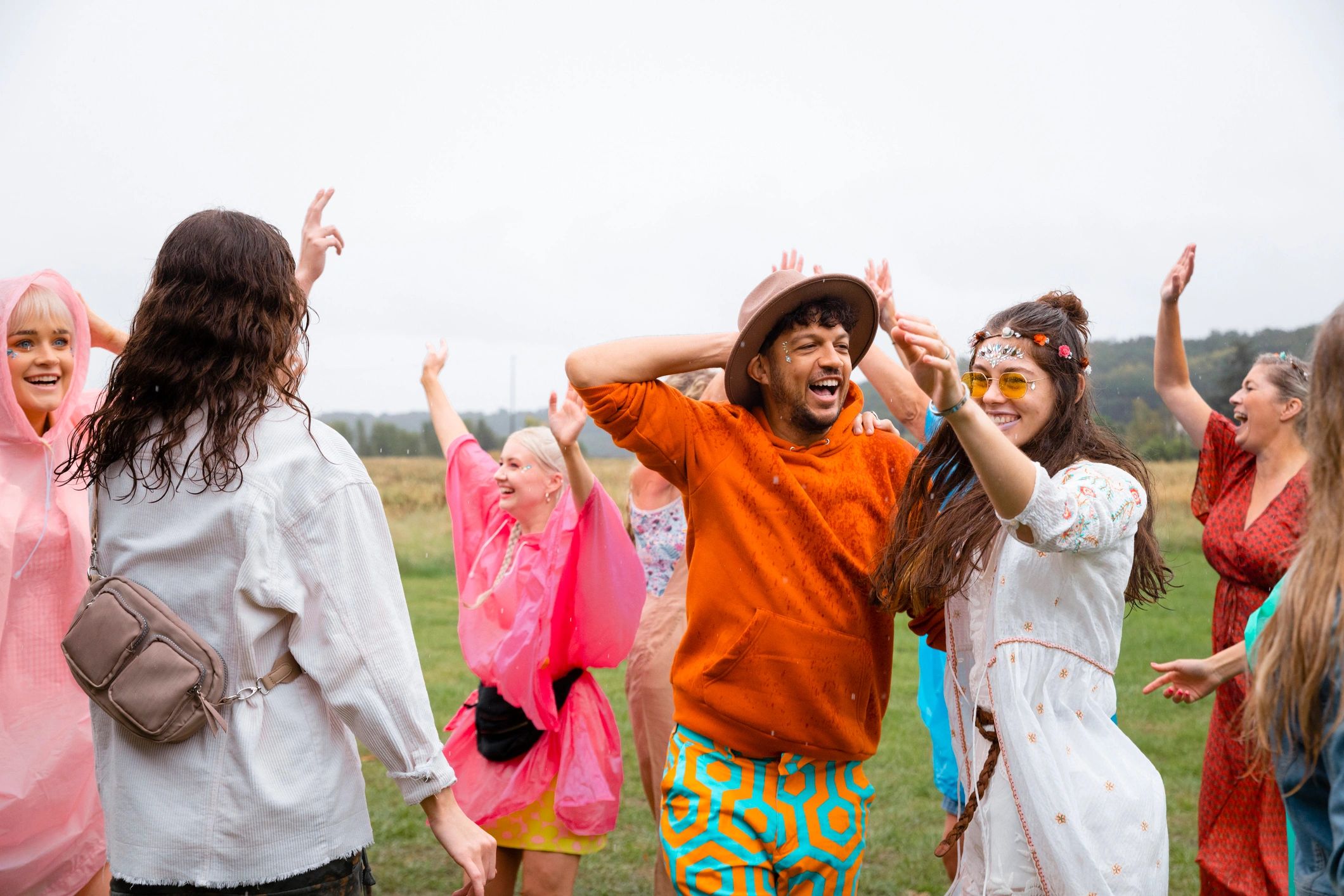 Group of friends singing and dancing at a festival