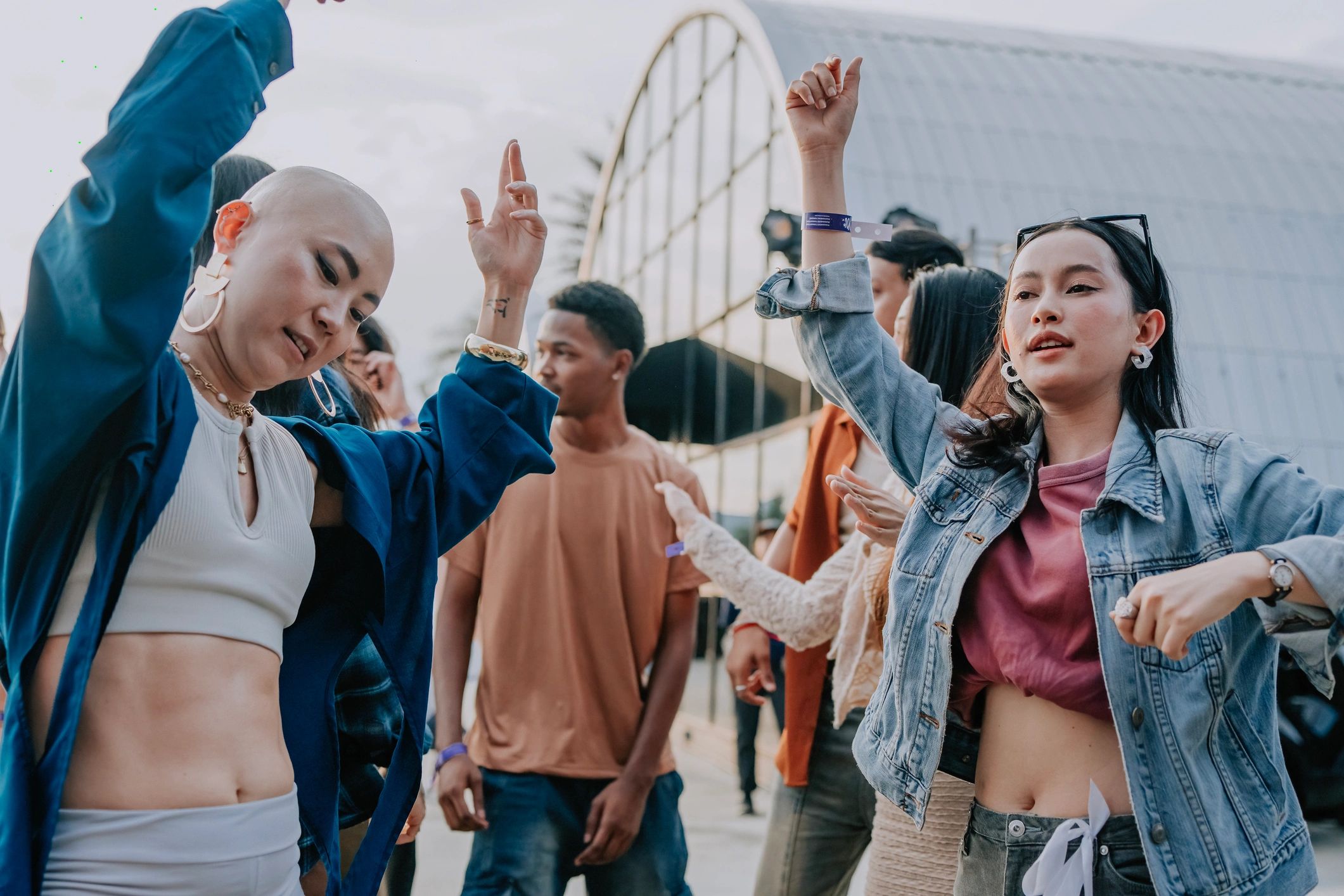 Friends dancing at an outdoor music festival